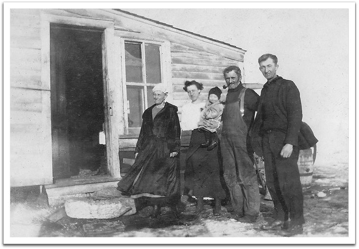 George and Maggie Reitter with Maggie's parents, John and Lena Huff, in 1919,  probably at John & Lena Huff’s house near Goodrich, North Dakota. L-R: Lena Huff, Maggie Reitter, Leona Reitter, John Huff, George Reitter.  In this photo, George looks quite tall, but his height is likely exaggerated  by being closer to the camera than the others; his height was 5’8”.