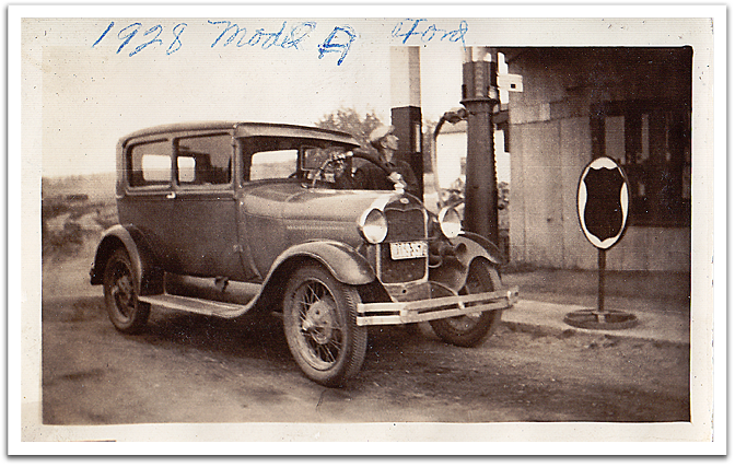 George Reitter pumping gas into a 1928 Ford Model A at the east garage, sometime after 1936.