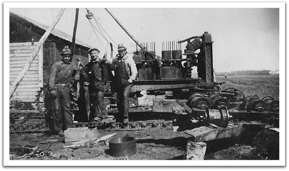 George Reitter in the middle, working on machinery, probably while working on road construction, about 1937-‘38.