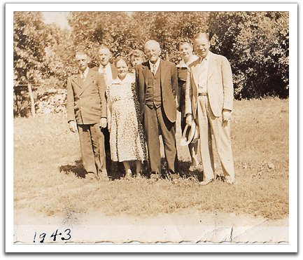 The Ole K Flateland family in 1943,minus Oscar  who was serving in the Army in the South Pacific.  L-R: Ted, Knute, Anlaug, Lola, Ole K, Birdie, Ole.