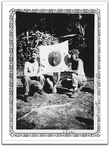 Oscar on the left, with a Japanese flag they found after landing on Guadalcanal.