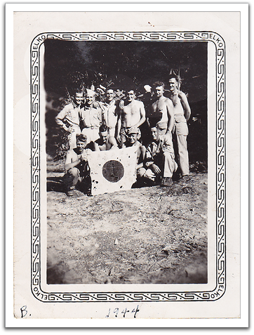 Oscar, lower left, posing with captured Japanese flag. The “B.” notation on the bottom of these photos, likely made by Helen later, indicates the photo was taken on Bougainville.