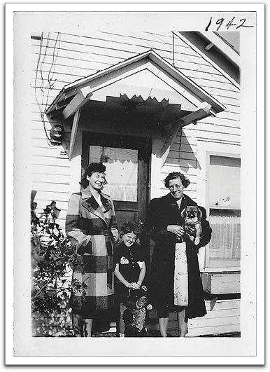 Leona & Maggie (holding Pegs) with a neighbor girl in front of the Reitter house, 1942.