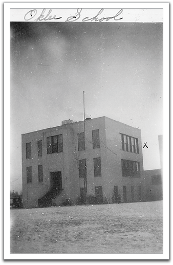 Oklee School, about 1943.  Grades 1-12 were taught in this building  and the small addition to the right.  The bottom floor of the building was partly below-grade, so was called “the dungeon.”