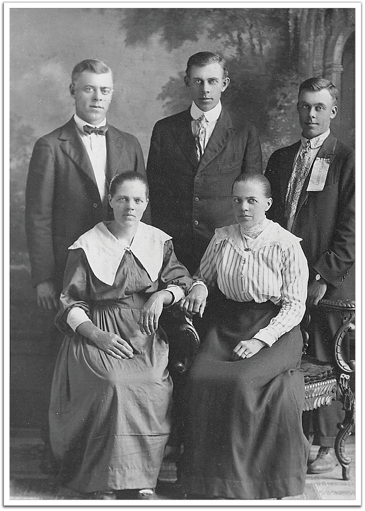 Anlaug Bjugsson (Flateland) and her siblings. Back, L-R: Ben (Bjug), Sam (Sigurd), Halvor. Sitting, L-R: Anna (Anlaug) Flateland, Torbjorg Kvasager. Judging from the age appearance of Halvor, who was born in 1894, this photo was likely taken between about 1910 and 1918.