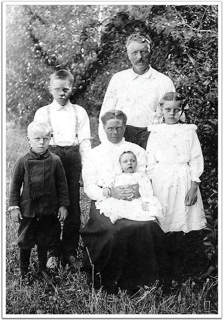 Ole K and Anna Flateland and their growing family, summer of 1912. Back row, L-R: son Knute, Ole K Front row, L-R: son Ole, Anna holding baby Ted, and Birgit (Birdie).