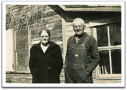 Anna & Ole K about the time they were  building their new house, 1943. The house behind  them is believed to be Knute's.