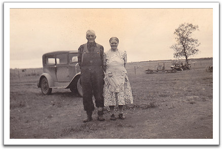 Ole K & Anna in front of a Model A which may have belonged to the Gundersons (Ole & Birdie), early 1940s.
