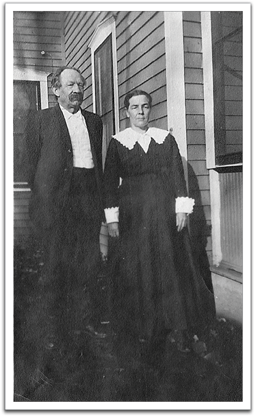 John Fredrick Reitter with his second wife,  Eva C. (Sanford) Reitter. Photo taken in front of the house on their farm, probably between 1910 and 1920, in Sheridan County, ND.