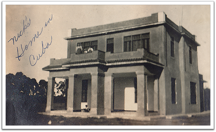 Nick Huff's house in Cuba, circa 1920s. It was protected by a tall fence to keep out the locals  as some of the Cuban people were hungry at the time and wanted to break in to plunder. The three figures on the balcony, top left, may be Nick and members of his family.