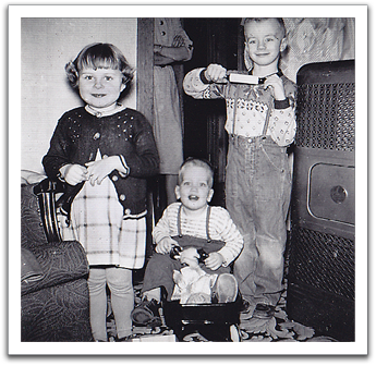 Bonnie, Myles, and Byron, obviously pleased with the rolling pin gift he had received.
