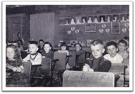 Byron in class, February, 1957. Others identifiable from recollection are Barbara Bronken, far left, Joyce Nelson, 3rd from left, Lois Plante behind her, and Duane Asselin, far right.