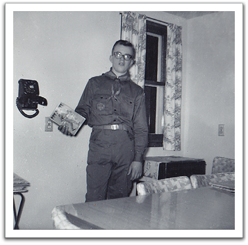 Byron proudly showing off his new Scout uniform  and Boy Scout Manual, February, 1964.