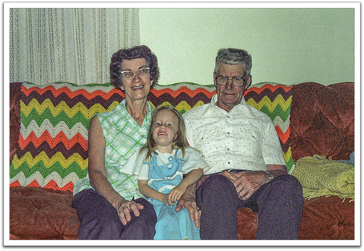 Helen, Kirsten, Oscar sitting in front of a ripple afghan Jill made for Helen & Oscar for Christmas,   summer, 1981, J&B’s house.