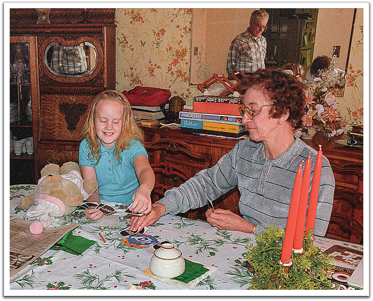 Kirsten playing Uno with Grandma Helen, Oscar observing in the background, December 1986,  J&B’s house.