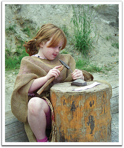 Crystal trying her hand at creating a rune, or letter, in the Old Norse alphabet in use during Viking times, summer, 1996, at a reconstructed Viking village outside of Oslo.