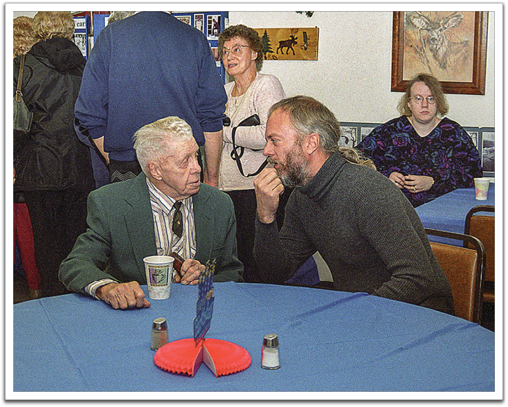 Oscar chatting with Myles at Oscar’s 90th birthday party, February 4, 2004, Oklee Community Club.